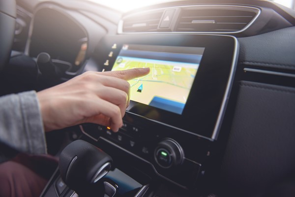 Hand using GPS navigation in a car