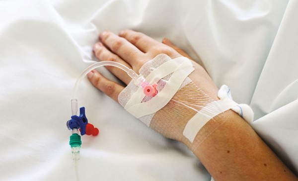 IV drip inserted in woman's hand.
