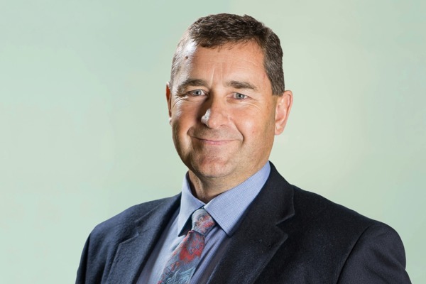Portrait of Johan van der Westhuizen, looking at the camera with a neutral expression against a plain background.